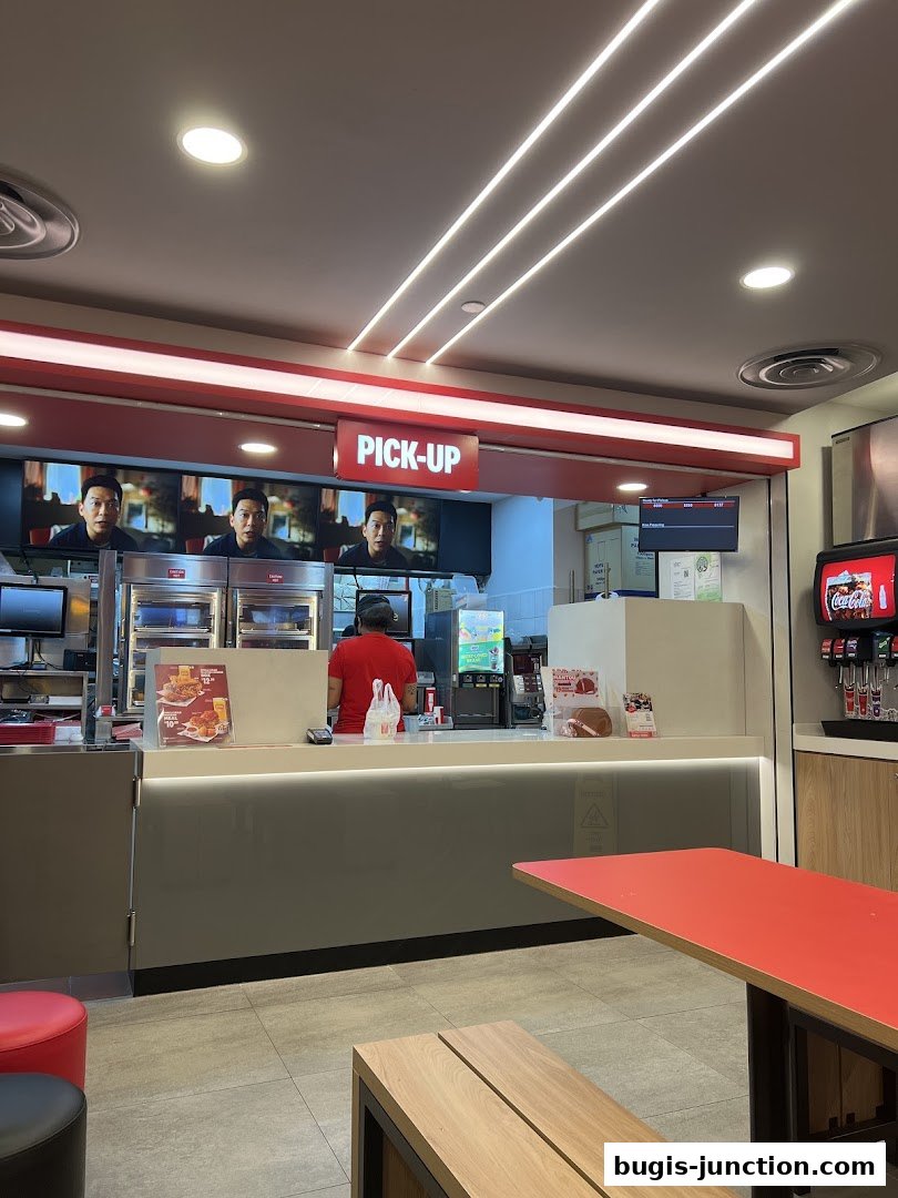 Interior view of a KFC restaurant with a pick-up counter and seating area.