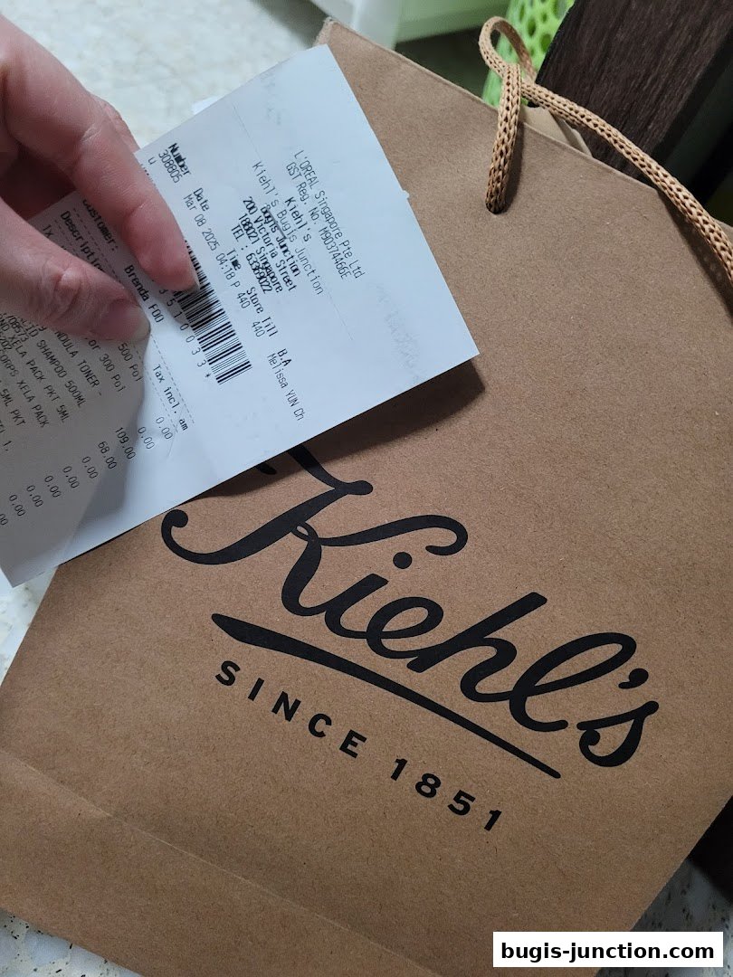A Kiehl's shopping bag with a receipt showing purchased items.