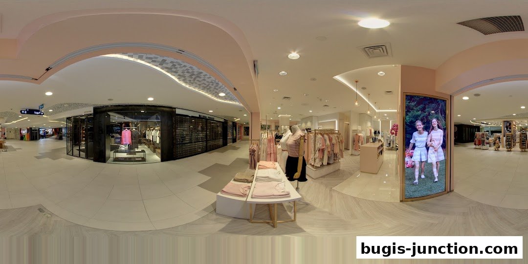 Interior view of a clothing store with mannequins and racks of apparel.
