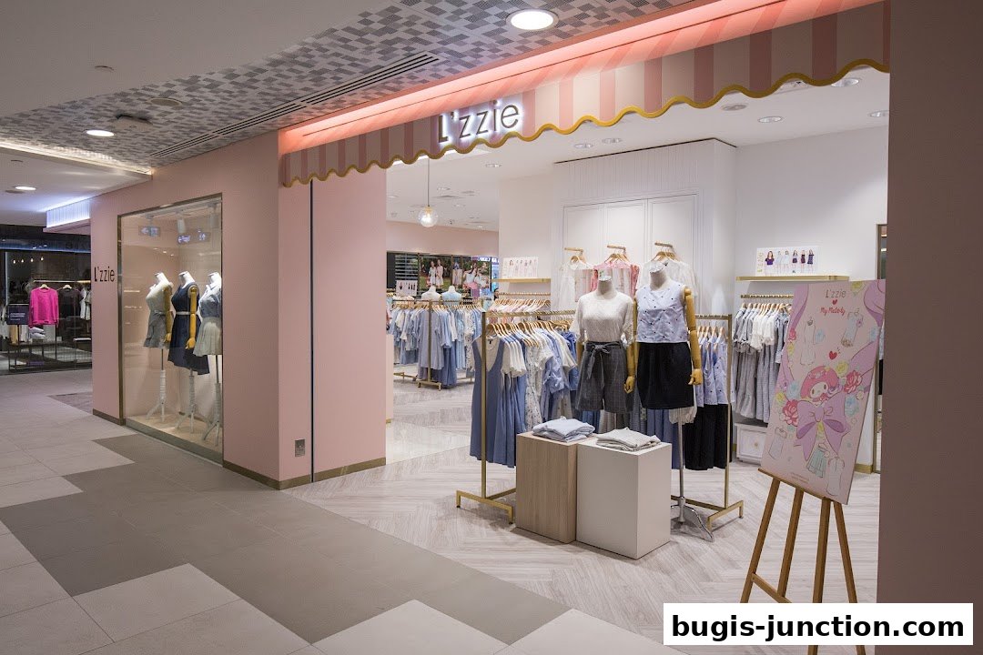 The entrance of a clothing store named Lzzie, featuring mannequins and racks of apparel.