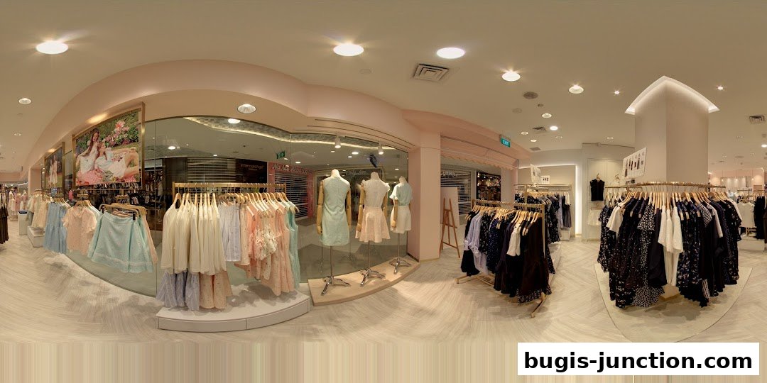 Interior view of a clothing store with mannequins and racks of women's apparel.