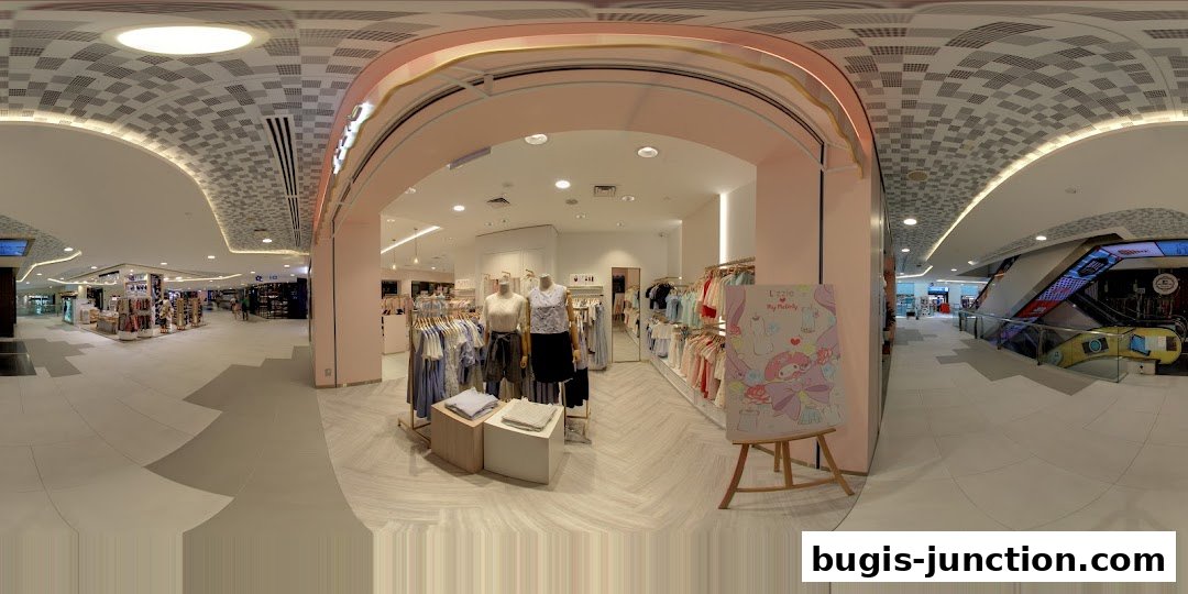 The entrance of the Lzzie clothing store, showcasing mannequins and apparel.