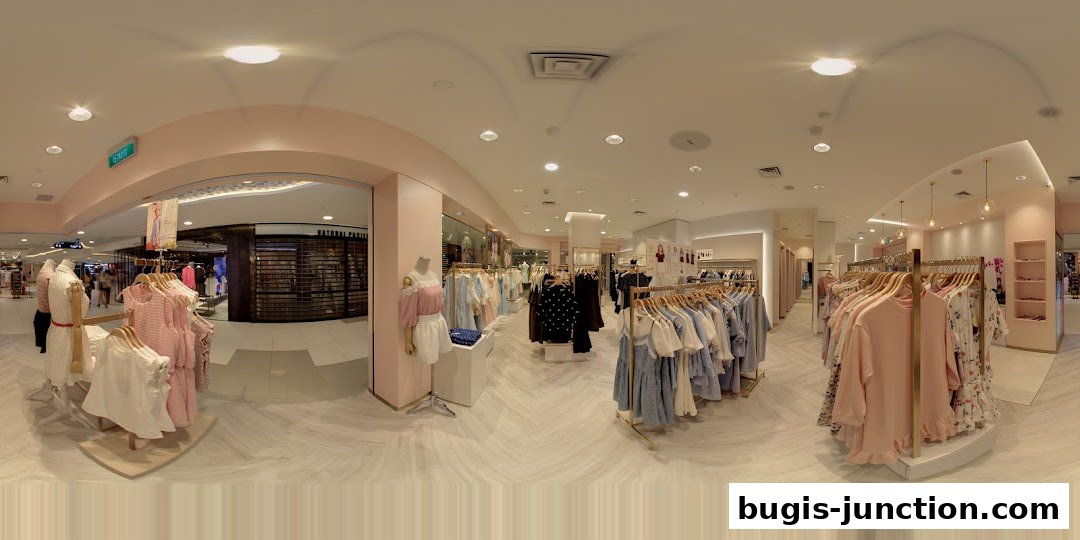 Interior view of a clothing store with racks of women's apparel and mannequins.