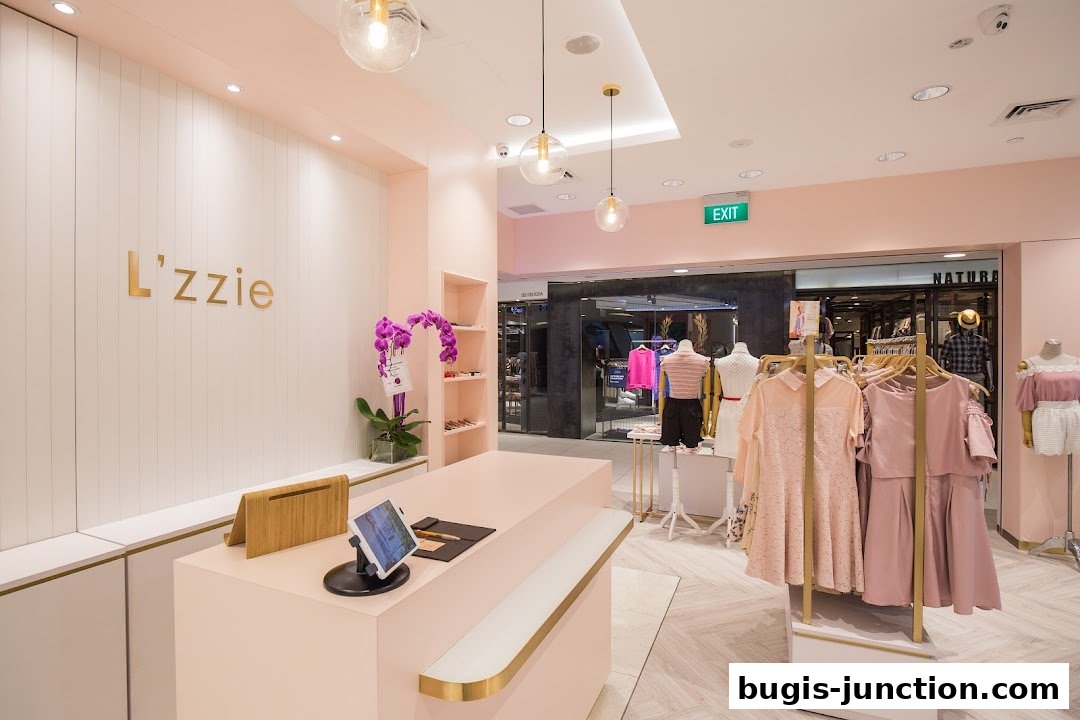 Interior view of a stylish clothing boutique with pink accents and mannequins displaying outfits.