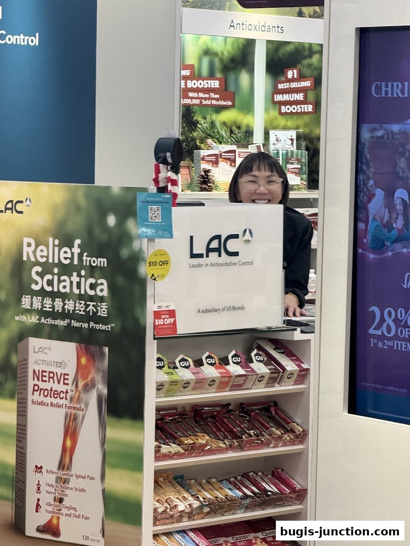 A smiling employee stands behind a counter displaying health and wellness products.
