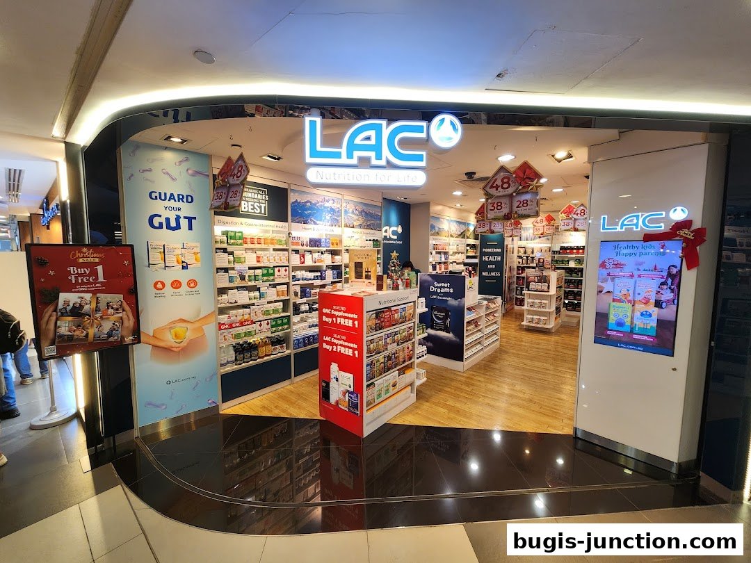 The entrance of LAC Nutrition For Life, a health and wellness store, showcasing various supplements and promotions.