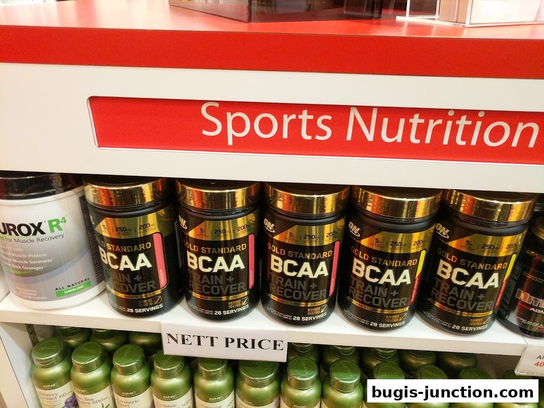 Shelves stocked with various sports nutrition supplements, including BCAA and protein powders.