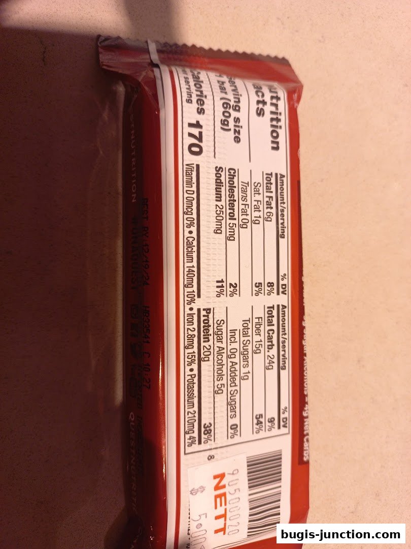 Close-up of a nutrition label on a red food bar wrapper.