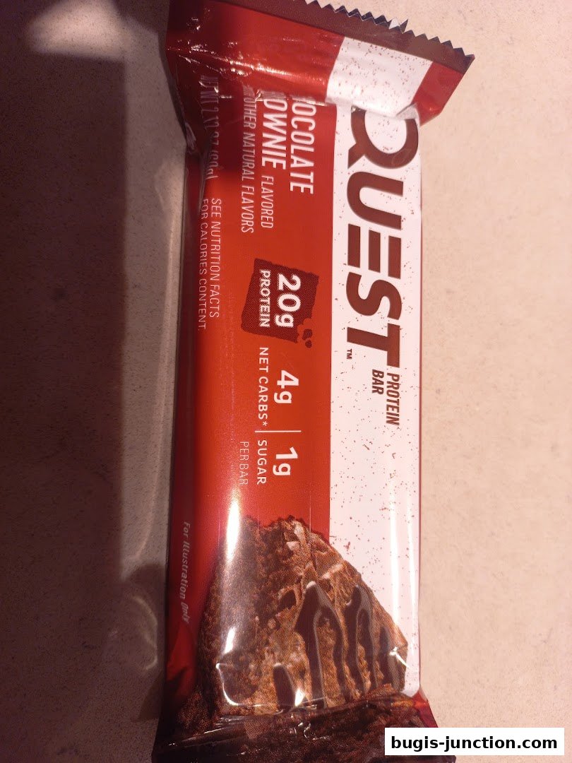 A Quest protein bar with chocolate brownie flavor, highlighting 20g protein and low net carbs.