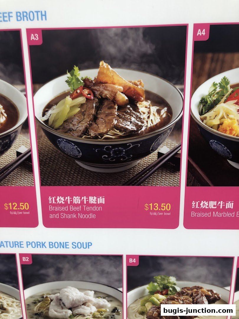 A menu display featuring various noodle dishes with appetizing images and prices.