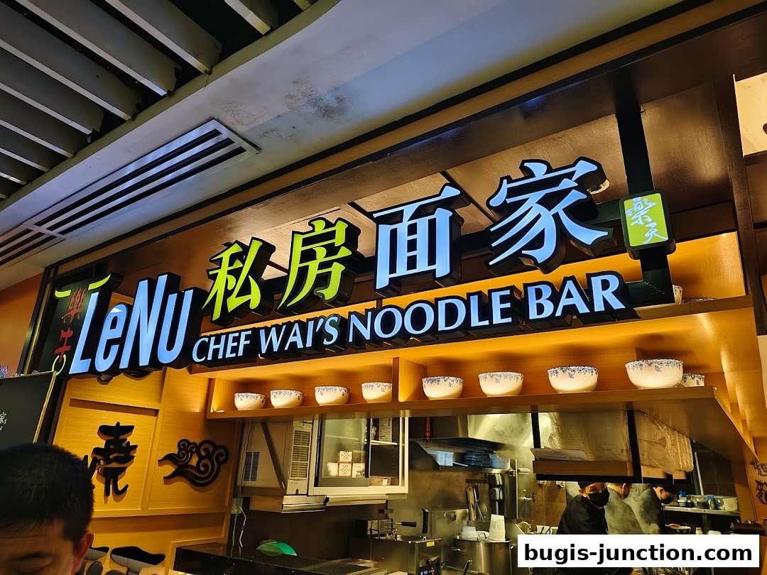 LeNu Chef Wai's Noodle Bar sign and interior kitchen view with chefs.