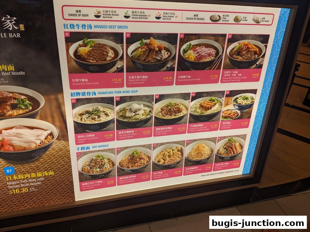 A menu board displaying various noodle dishes with images and prices at LeNu Chef Wais Noodle Bar.