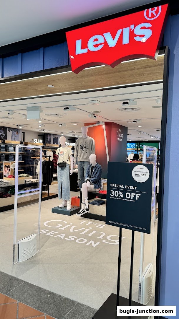 The entrance of a Levi's store with mannequins displaying clothing and a special event promotion.