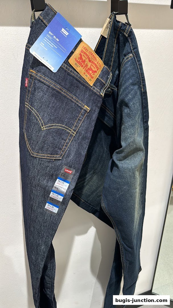 A pair of dark wash Levi's 511 Slim jeans with tags displayed.