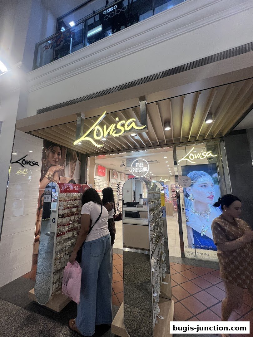 The entrance of a Lovisa jewelry store with displays of earrings and promotional signage.