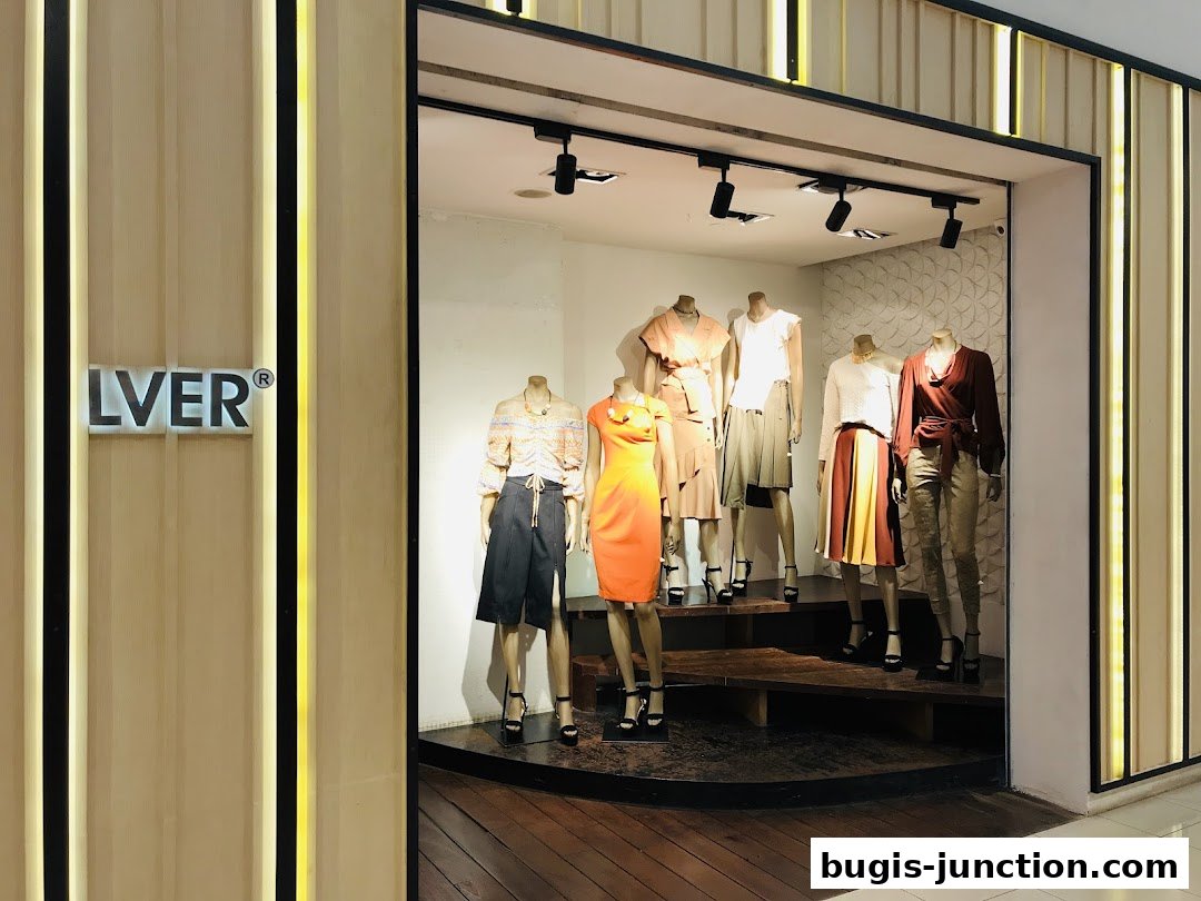A fashion store window display featuring mannequins dressed in stylish outfits.