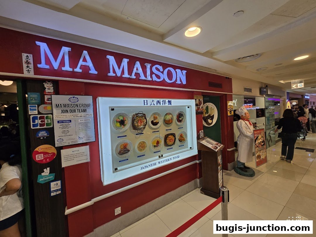 The exterior of the MA MAISON restaurant, featuring a display of Japanese Western food dishes.