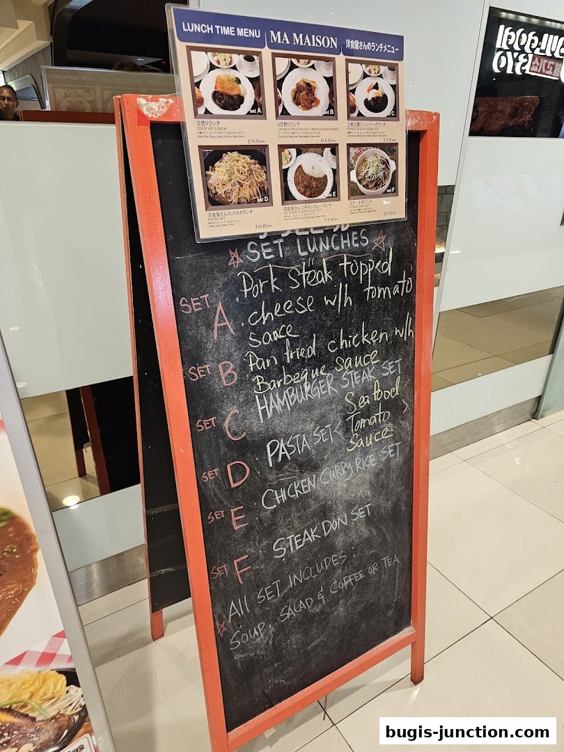 A chalkboard menu displays various set lunch options with descriptions and prices.