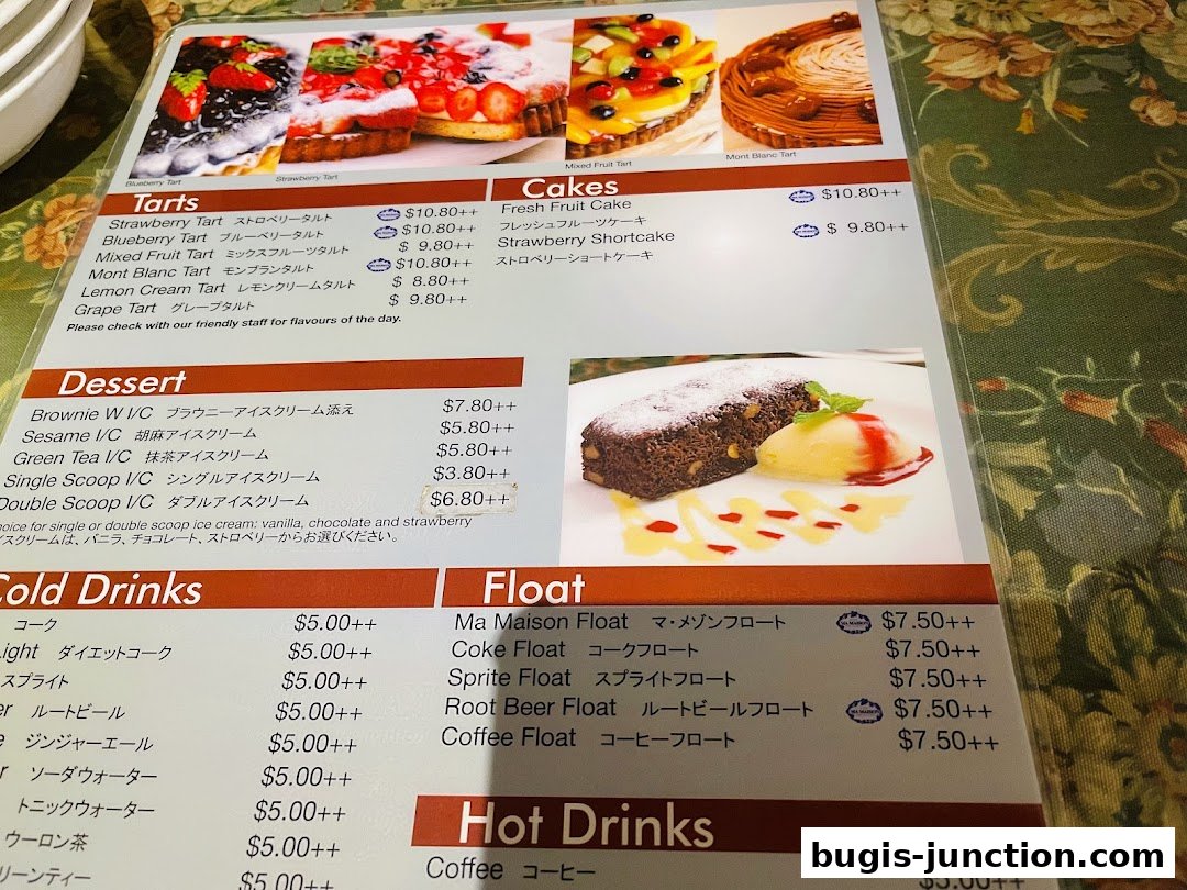 A menu featuring tarts, cakes, desserts, cold drinks, and floats with prices.