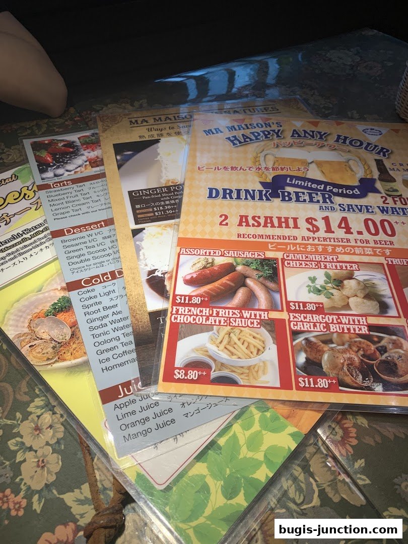 A collection of menus from MA MAISON, featuring food and drink specials.