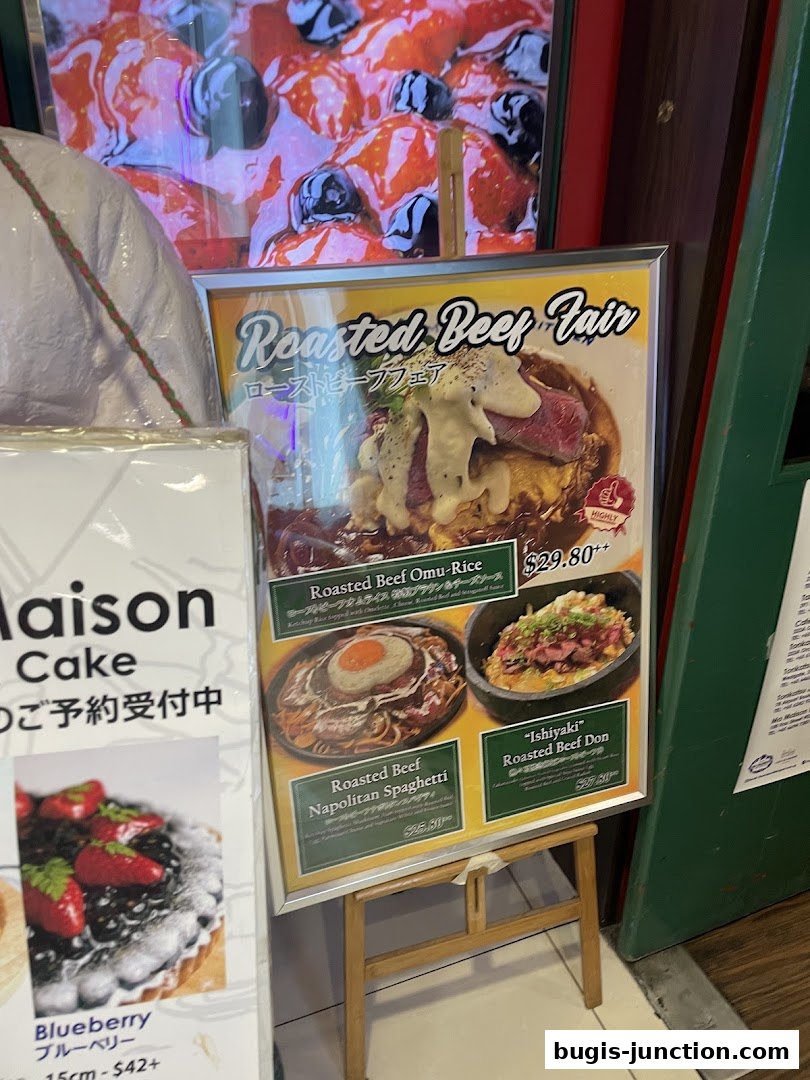 A display board showcasing various roasted beef dishes and a blueberry cake.
