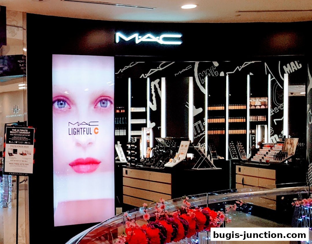 MAC Cosmetics store front with a large display featuring a model's face and makeup products.