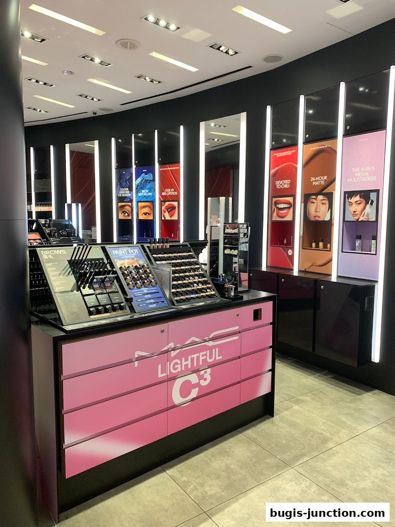 Interior view of a MAC Cosmetics store showcasing makeup products and promotional displays.