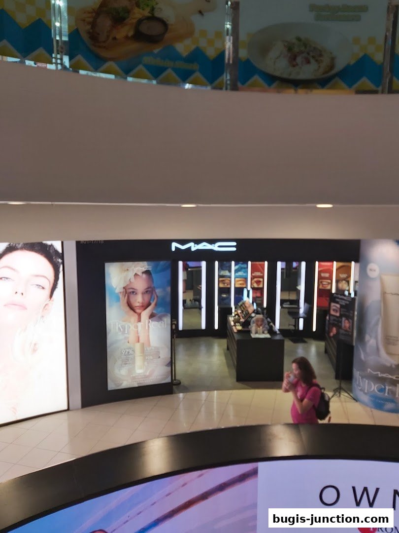 A MAC Cosmetics store entrance with product displays and advertising.