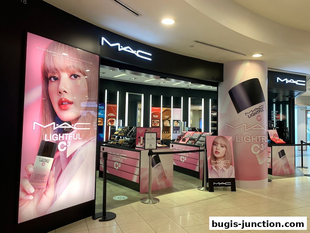 The MAC Cosmetics store features a large display with a model and product promotions.