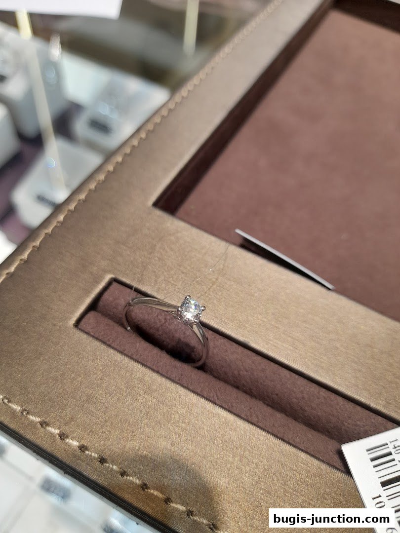 A sparkling diamond ring is displayed in a luxurious jewelry box.