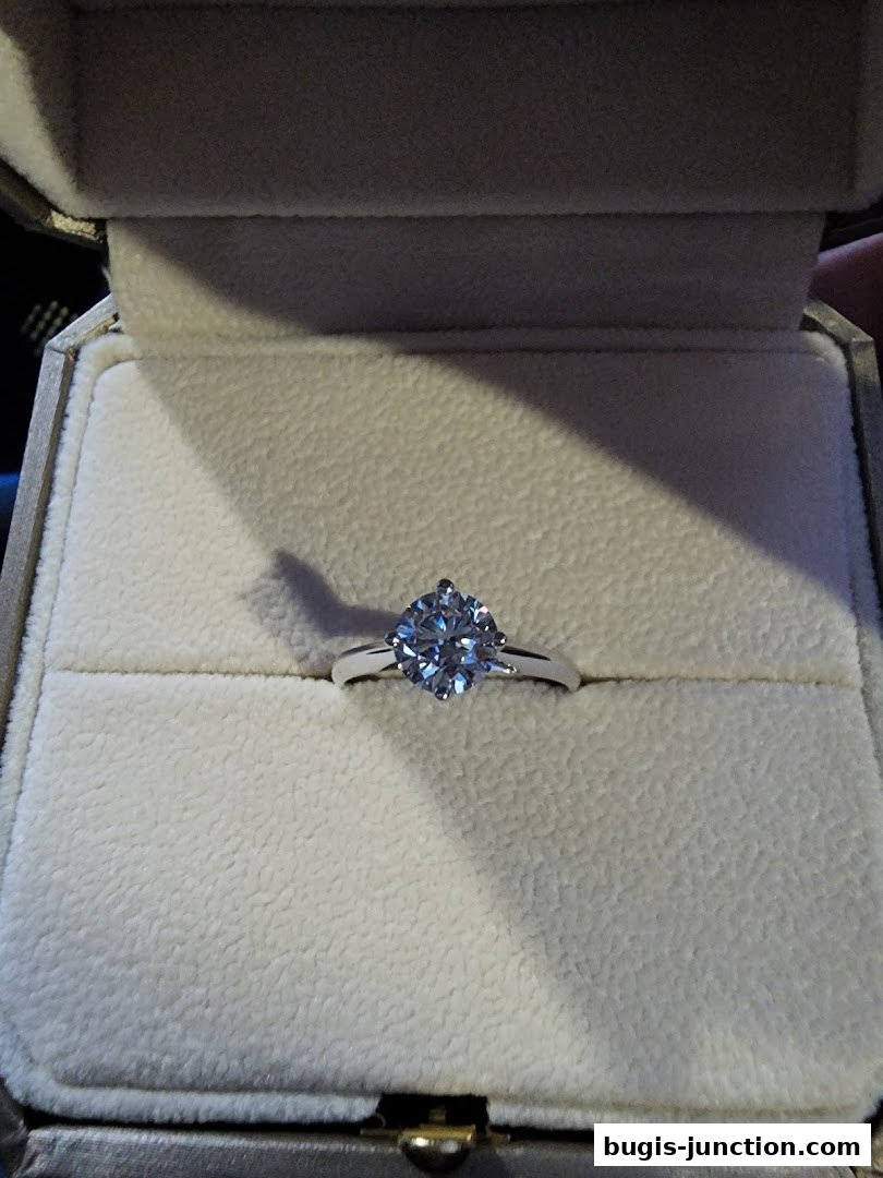 A sparkling diamond ring presented in a plush jewelry box.