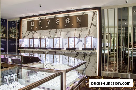 Interior view of Meyson Jewellery shop showcasing display cases filled with jewelry.