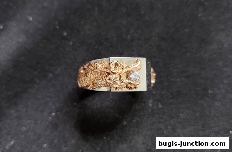 A close-up of a gold and silver ring featuring a detailed dragon design with a diamond.