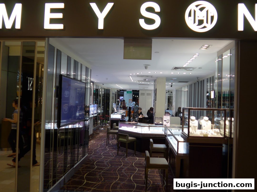 The entrance of Meyson Jewellery shop with illuminated signage and display cases.
