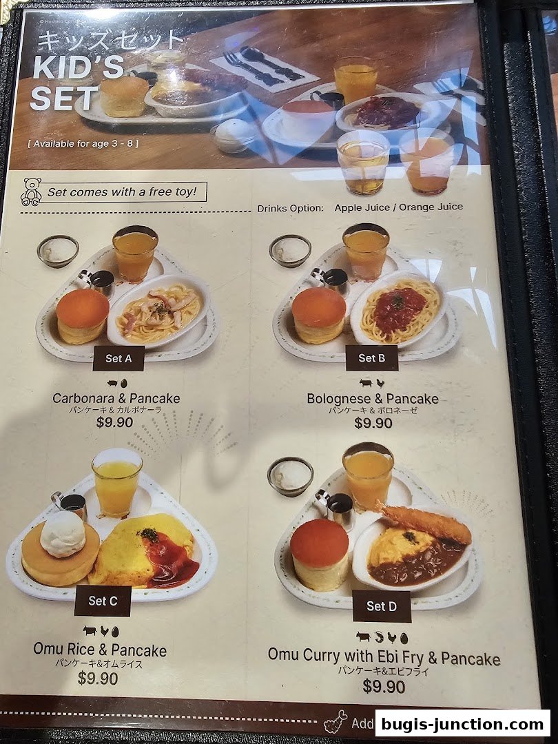 A menu showcasing four different Kid's Set meals with pancakes, pasta, rice, and drinks.
