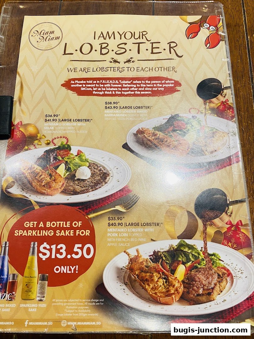 A menu from Miam Miam French Japanese Cafe Kitchen featuring lobster dishes and a sparkling sake promotion.