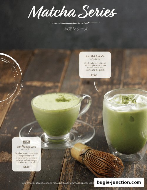 Two matcha drinks, a hot latte and an iced latte, with a whisk on a wooden table.