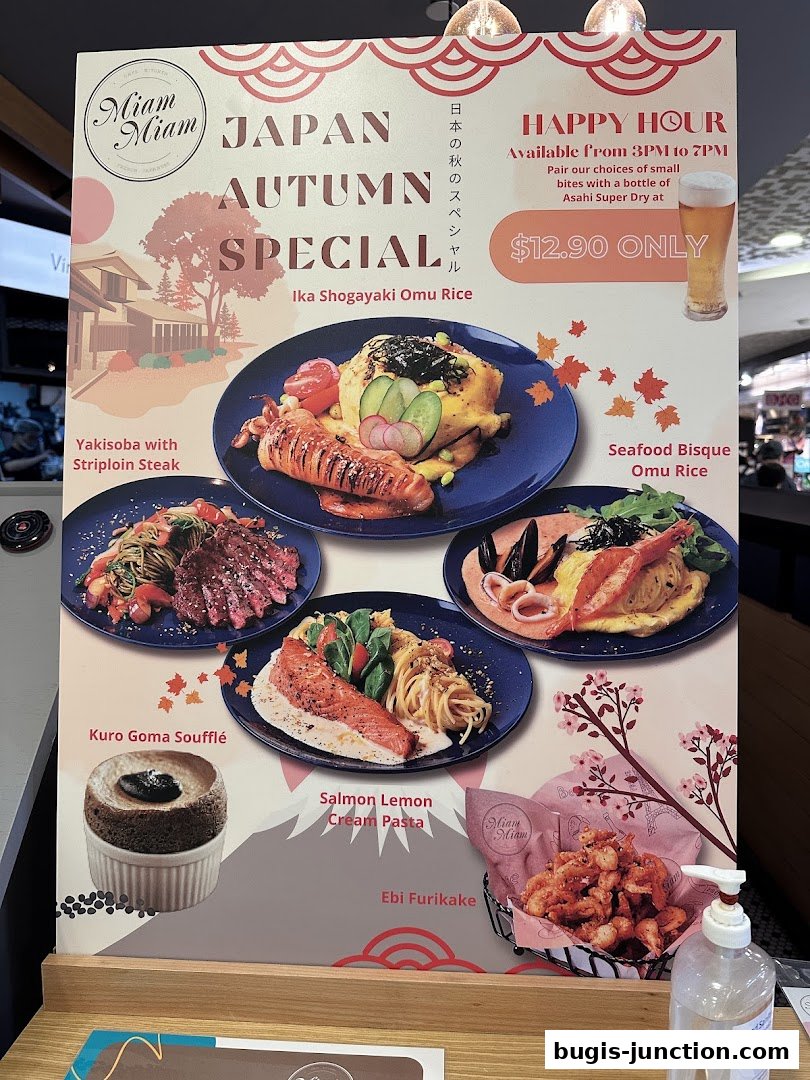 A menu board showcasing Miam Miam's Japan Autumn Special dishes and a Happy Hour offer.
