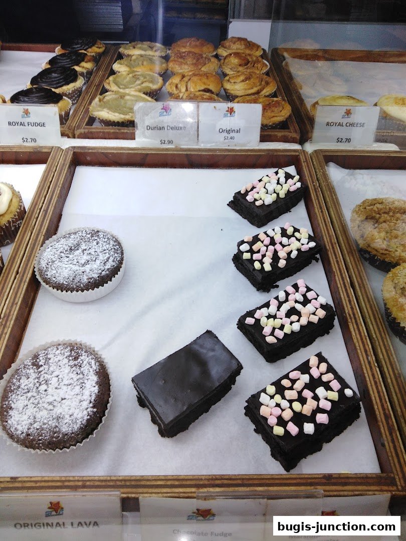 A display of various pastries and brownies, including cupcakes, tarts, and chocolate treats.