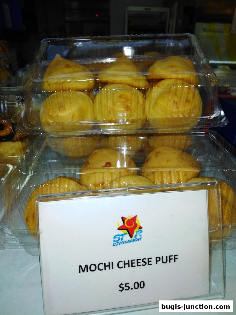 A close-up of Mochi Cheese Puffs in clear plastic containers, priced at $5.00.