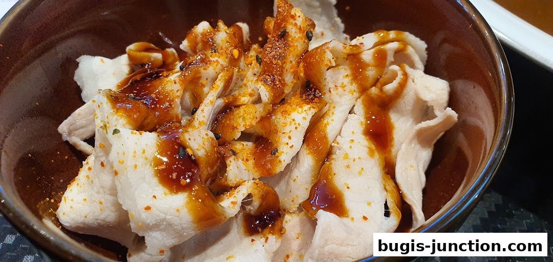 A close-up of thinly sliced pork belly drizzled with sauce and sprinkled with spices.