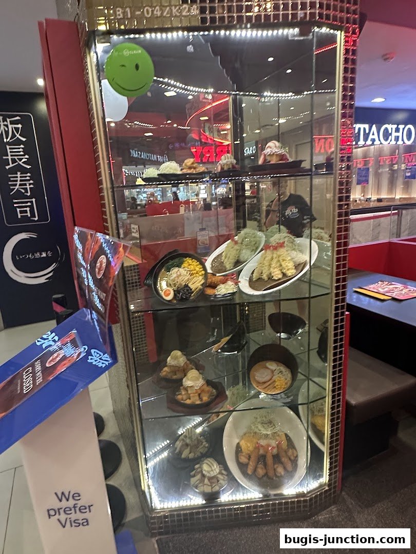 A display case showcasing realistic food models outside a Japanese restaurant.