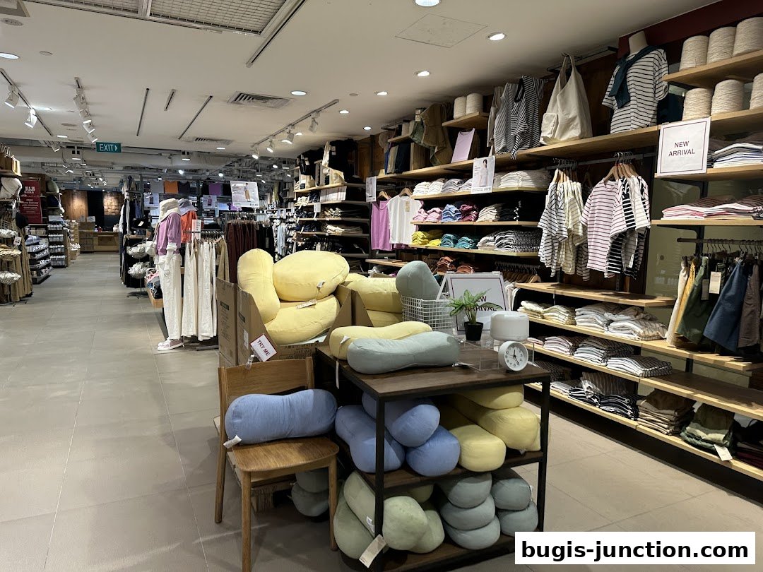 Interior view of a MUJI store showcasing clothing, home goods, and comfortable seating.