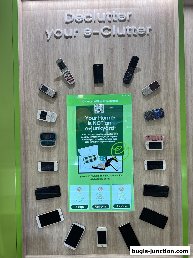 A display showcasing old mobile phones and a digital screen promoting e-waste recycling.