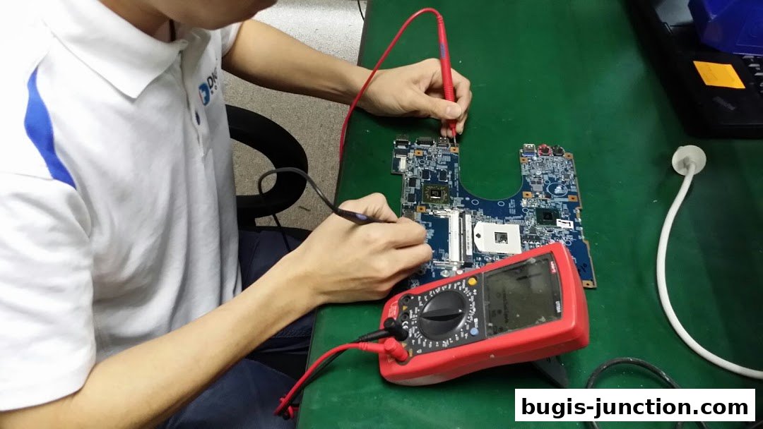A technician tests a computer motherboard with a multimeter.