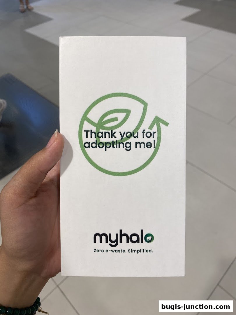 A hand holds a pamphlet from myhalo CircularXchange, a digital hospital focused on zero e-waste.