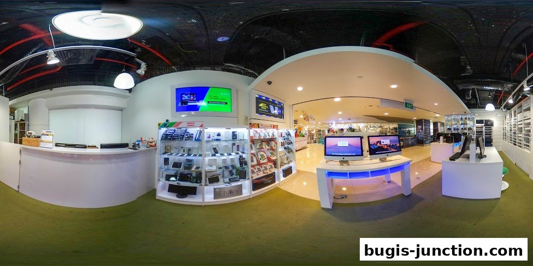 Interior view of a modern electronics store showcasing laptops, computers, and accessories.