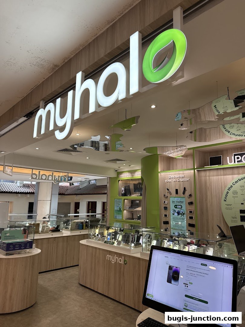 The interior of a modern electronics store with display cases filled with phones and laptops.