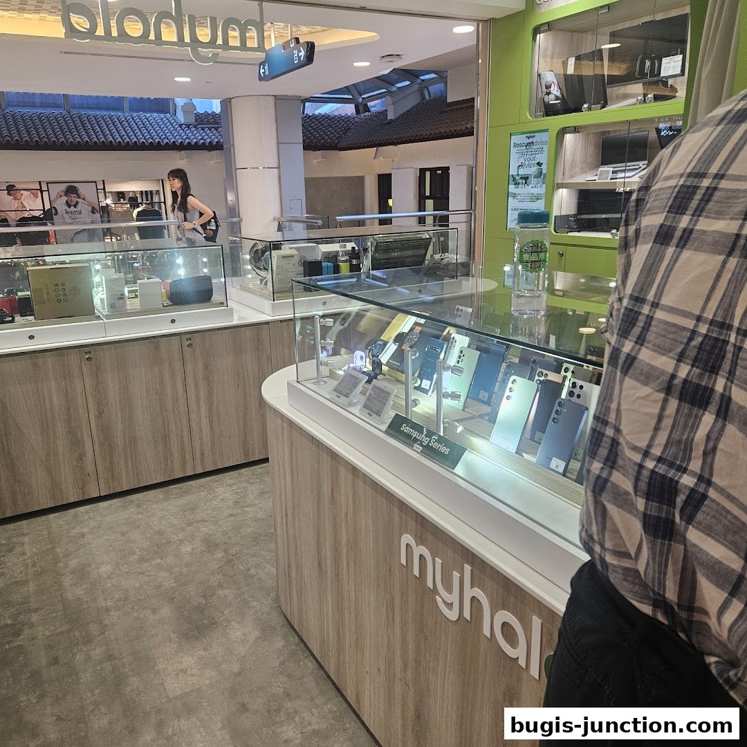 Interior view of a modern electronics store showcasing Samsung phones and other tech gadgets.