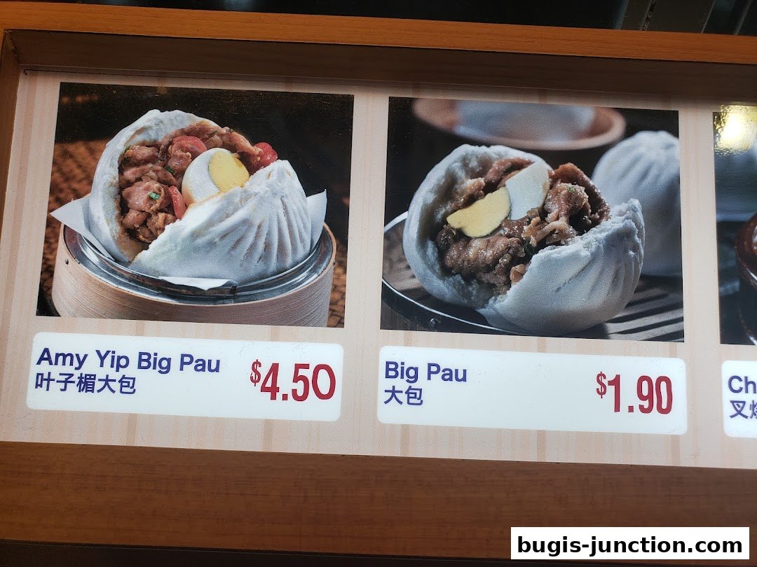 A menu display featuring two types of steamed buns with meat fillings and prices.